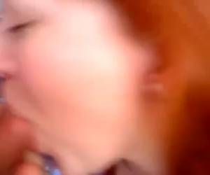 Cute redhead teen from Europe is not shy of having a camera in her face as she sucks a cock