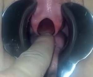 A duck clamp hold her pussy open while a nozzle into her urethra is
