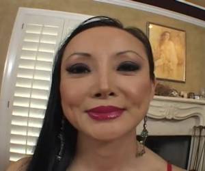 This Asian milf grabs him by the dick
