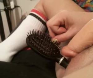 For the webcam she stops a hair brush in her pussy while she whiteh the dildo masturbate